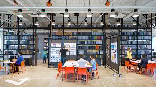 Bookshelves spanning wall with open collab seating